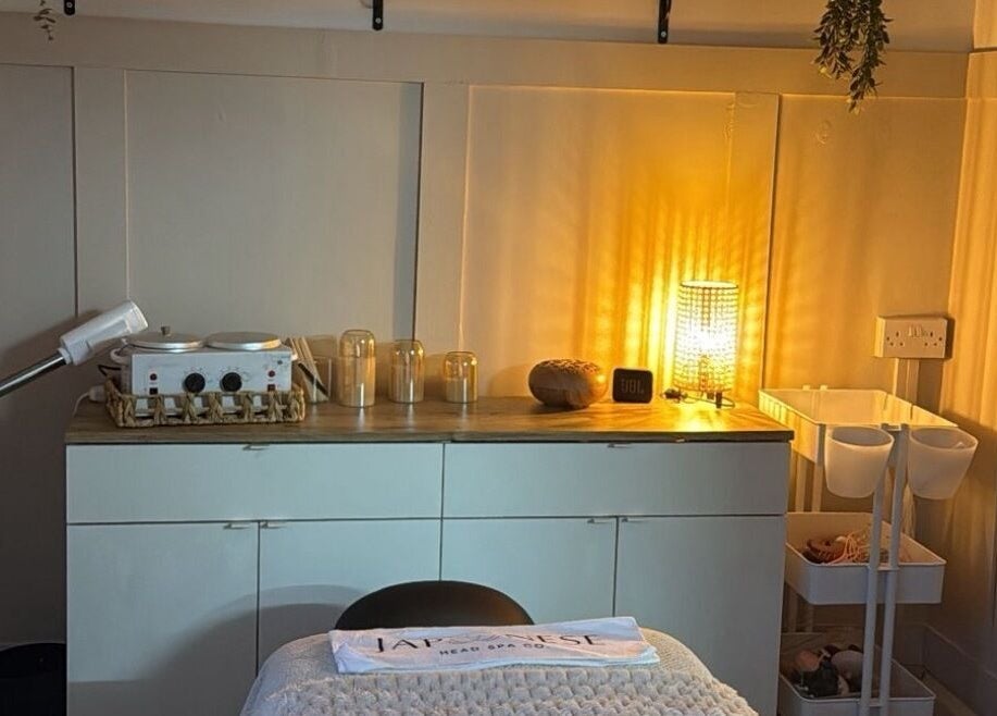 A warmly lit treatment room at Skin Perfected Ferring, Ferring, England, GB showcasing a tranquil atmosphere.