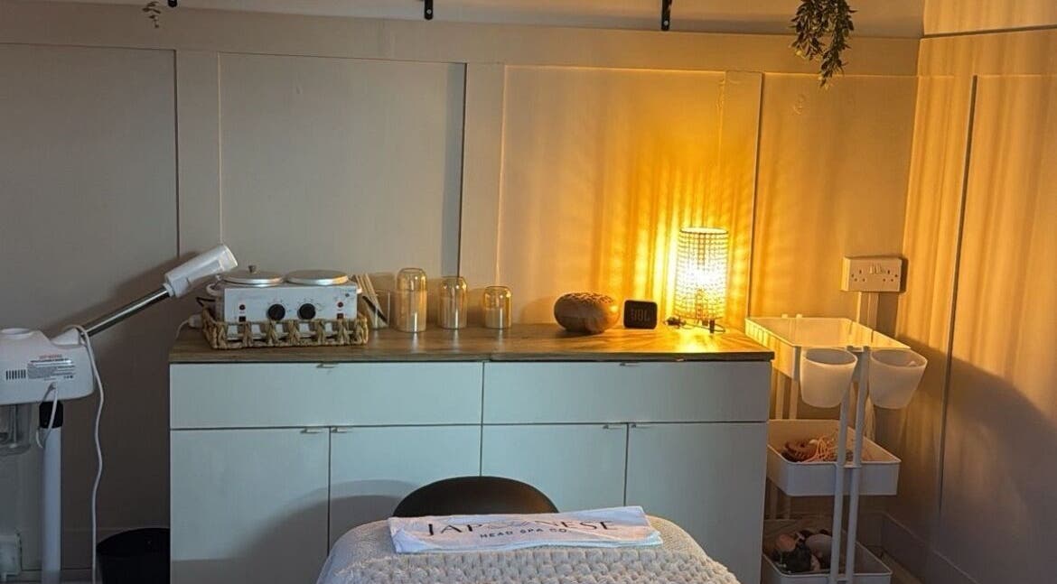 A warmly lit treatment room at Skin Perfected Ferring, Ferring, England, GB showcasing a tranquil atmosphere.