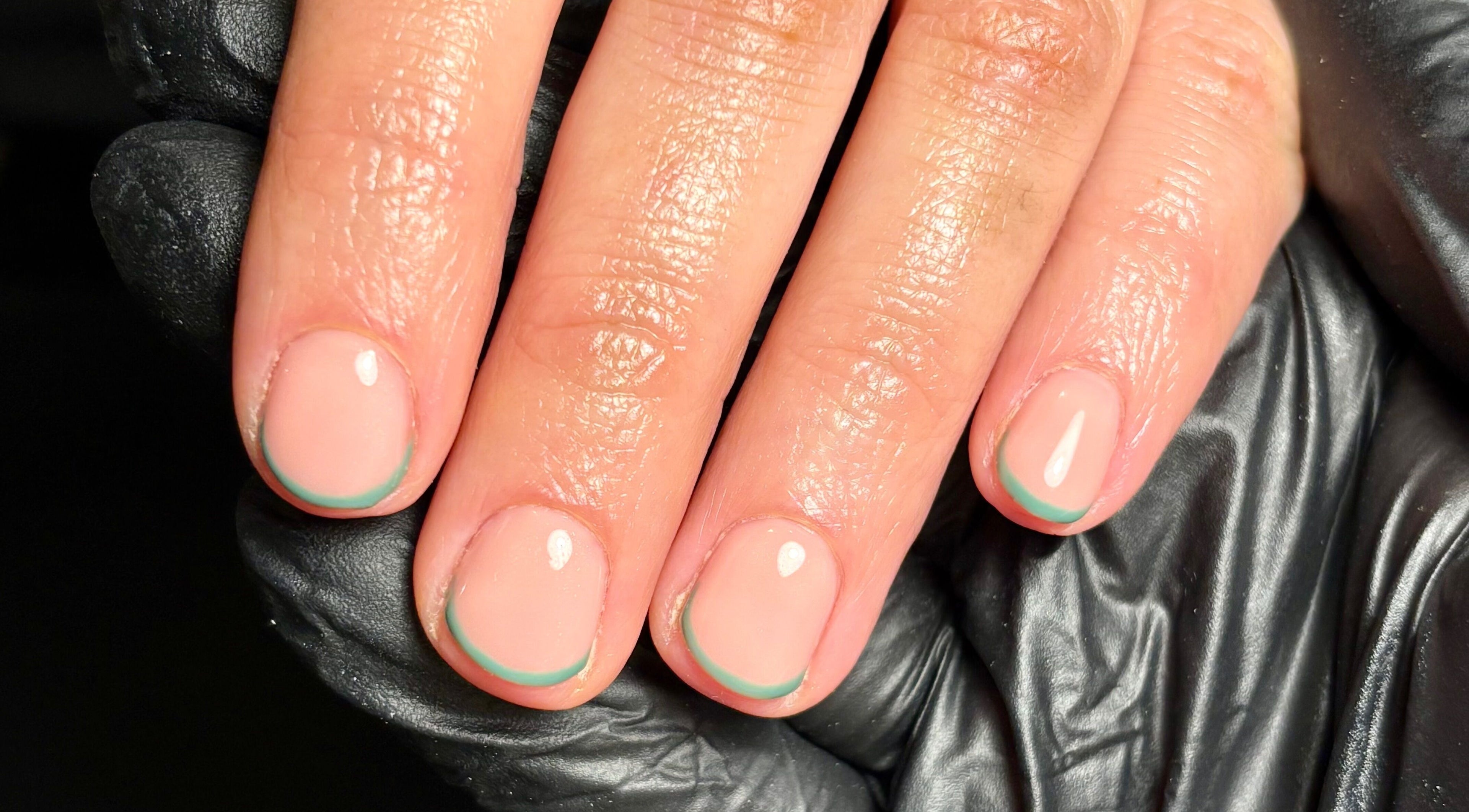 Stylish manicure at Fliss Beauty, Clitheroe, England, GB featuring glossy nails with a chic teal accent.