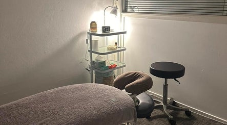 Serene therapy room at Northern Rivers Therapy in Ballina, New South Wales, AU, with a massage table and supplies.