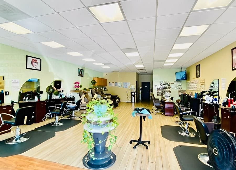Bright salon interior at Amazing Cuts in Sunnyvale, California, US, featuring modern chairs and decor.