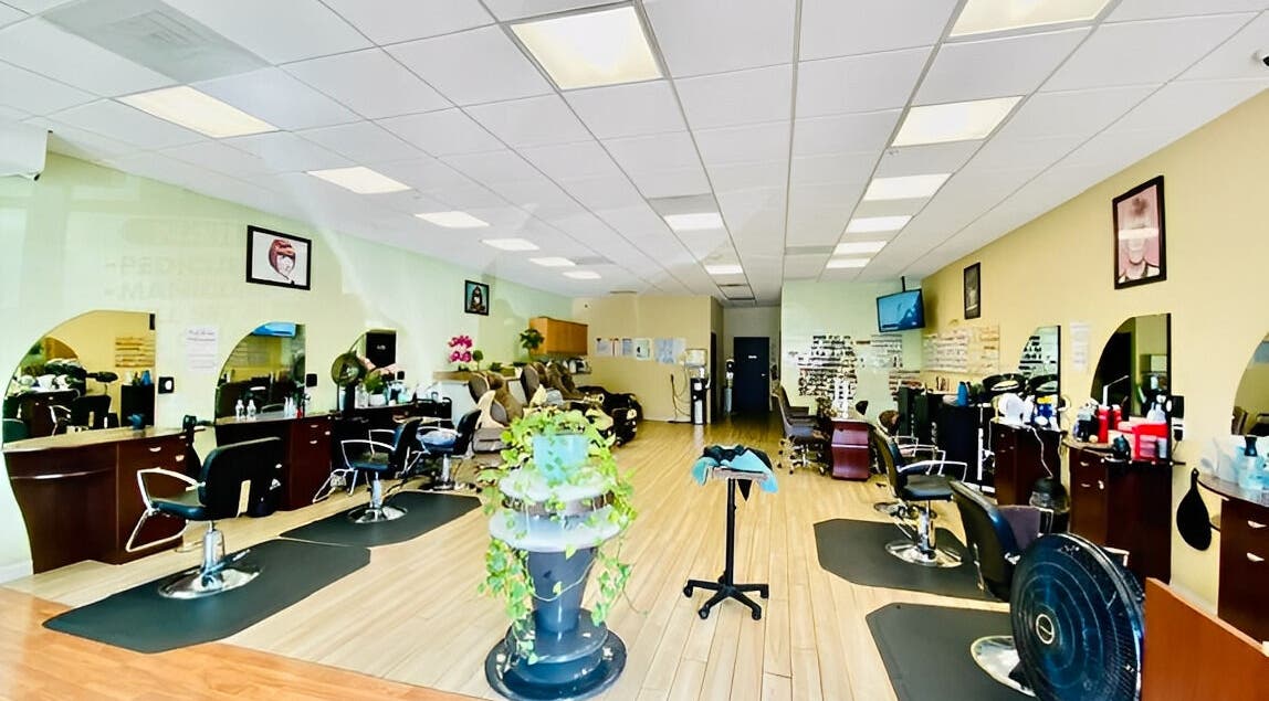 Bright salon interior at Amazing Cuts in Sunnyvale, California, US, featuring modern chairs and decor.