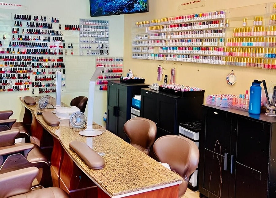 Nail salon with vibrant polish selection at Amazing Cuts, Sunnyvale, California, US.