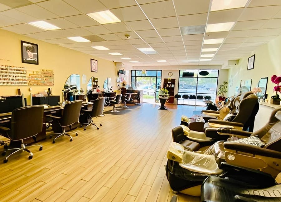 Spacious, modern interior of Amazing Cuts salon in Sunnyvale, California, US with chairs and nail stations.