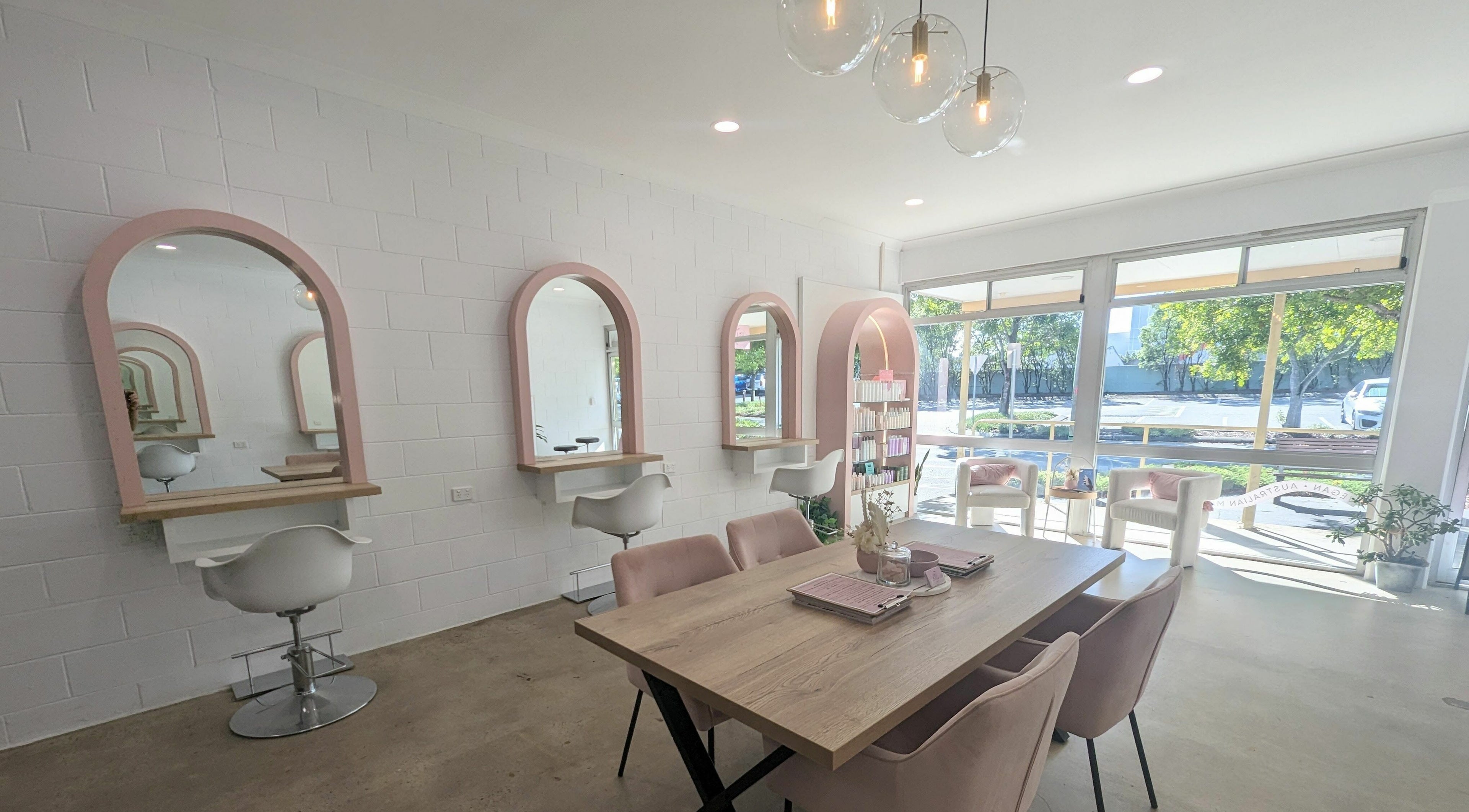 Modern interior of Project Hair Gold Coast in Nerang, Queensland, AU featuring stylish mirrors and seating.