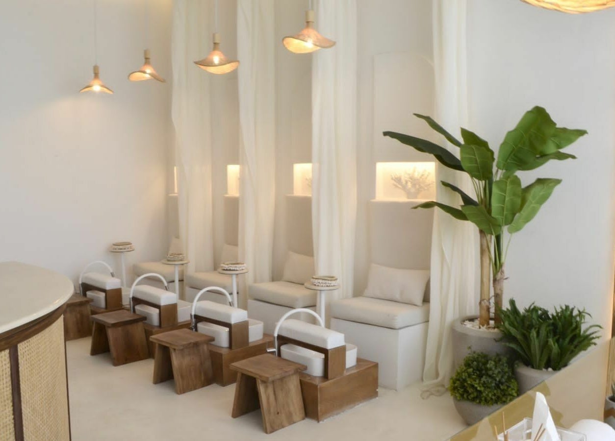 Relaxing interior of Cuteicles Nail Spa, Riyadh with cozy chairs and plants, perfect for unwinding.