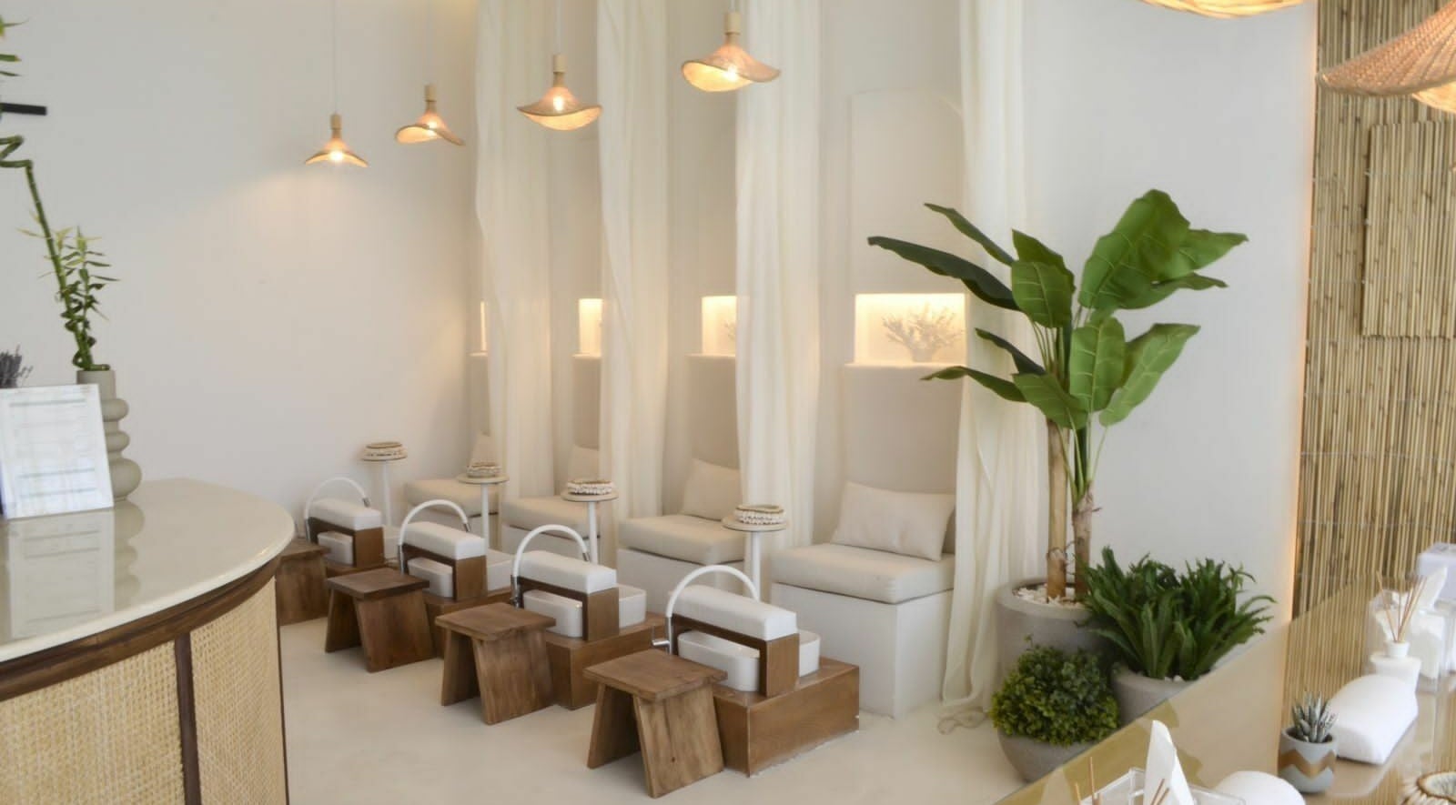Relaxing interior of Cuteicles Nail Spa, Riyadh with cozy chairs and plants, perfect for unwinding.
