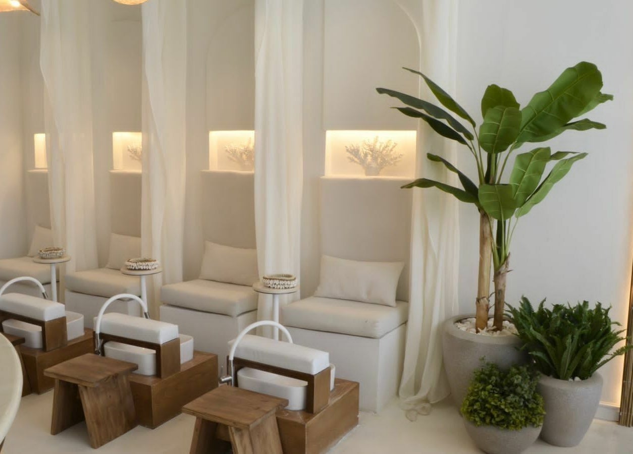 Relaxing treatment area at Cuteicles Nail Spa, Riyadh, Riyadh Province, SA with elegant seating and lush plants.