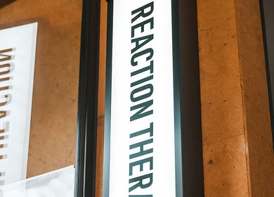 Sign displaying 'Reaction Therapy' at Wyndyke Furlong, Abingdon, England, GB entrance.
