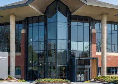 Modern glass building housing Reaction Therapy, Wyndyke Furlong, Abingdon, England, GB.