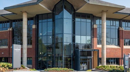 Modern glass building housing Reaction Therapy, Wyndyke Furlong, Abingdon, England, GB.
