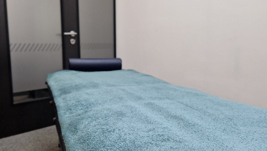 Calm therapy room at Reaction Therapy, Wyndyke Furlong, Abingdon, England, GB with a massage table.