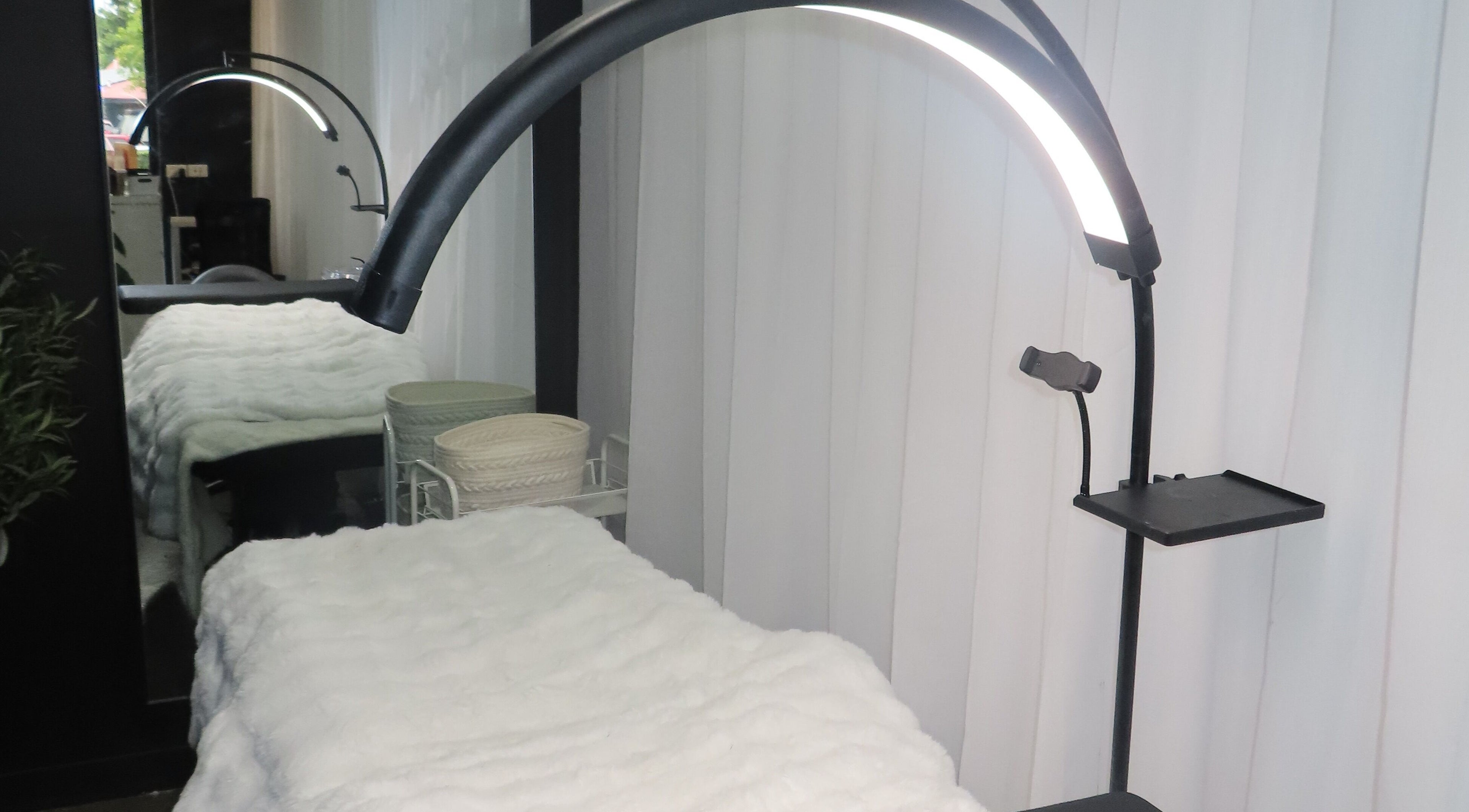 Cozy treatment bed with soft lighting at Kòha Beauty, Springfield, Queensland, AU.