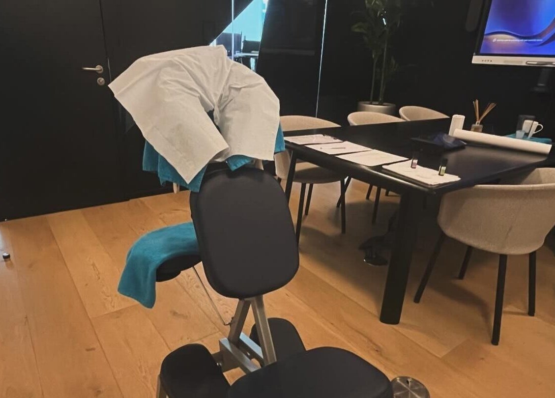 Comfortable massage chair at Elysian Therapies, South Ockendon, GB, surrounded by modern office decor.