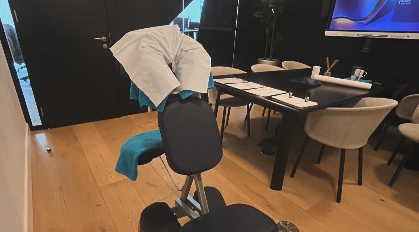 Comfortable massage chair at Elysian Therapies, South Ockendon, GB, surrounded by modern office decor.