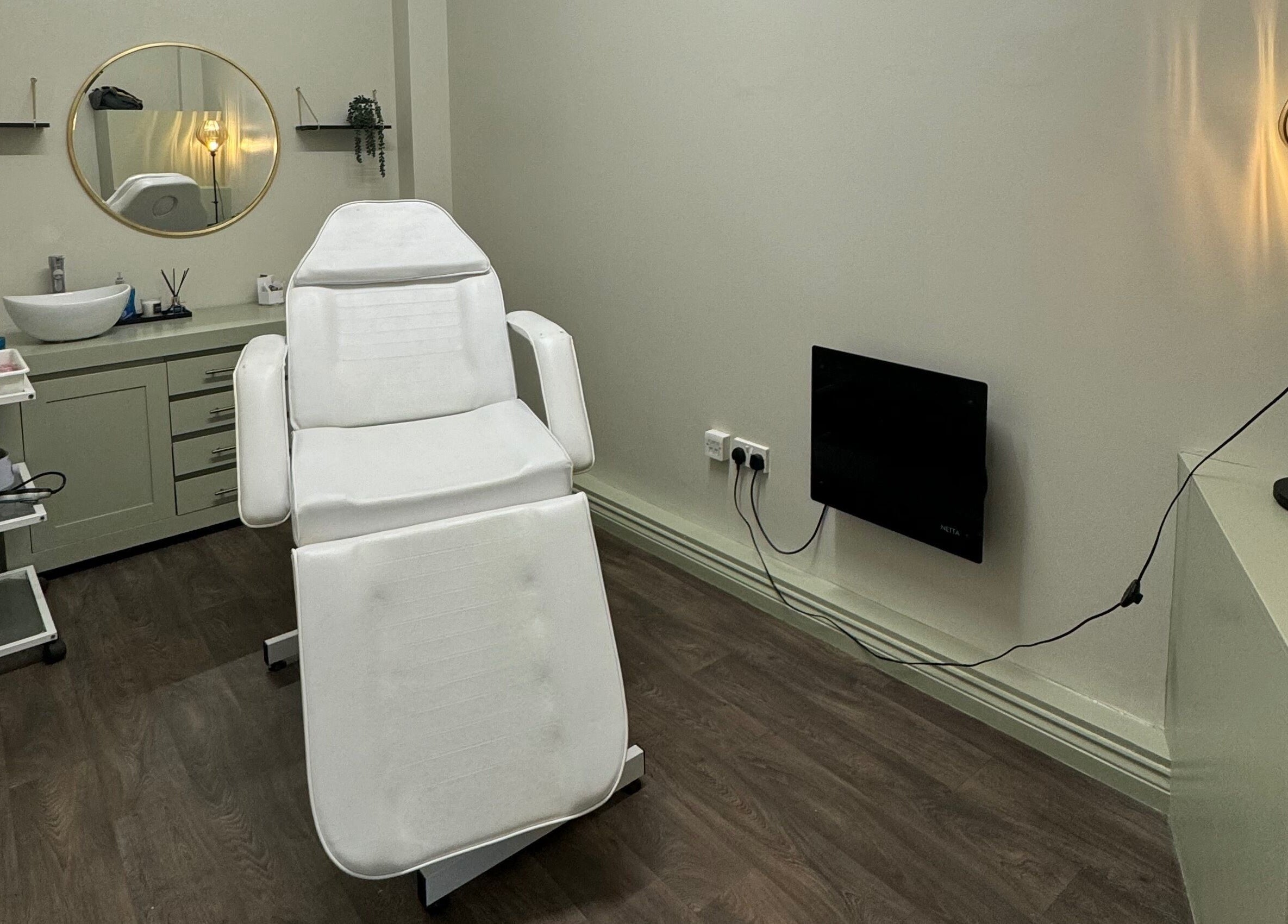 Relaxed ambiance at Bliss Beauty Bar treatment room in Ramsey, Ramsey, IM, featuring a comfortable spa chair.