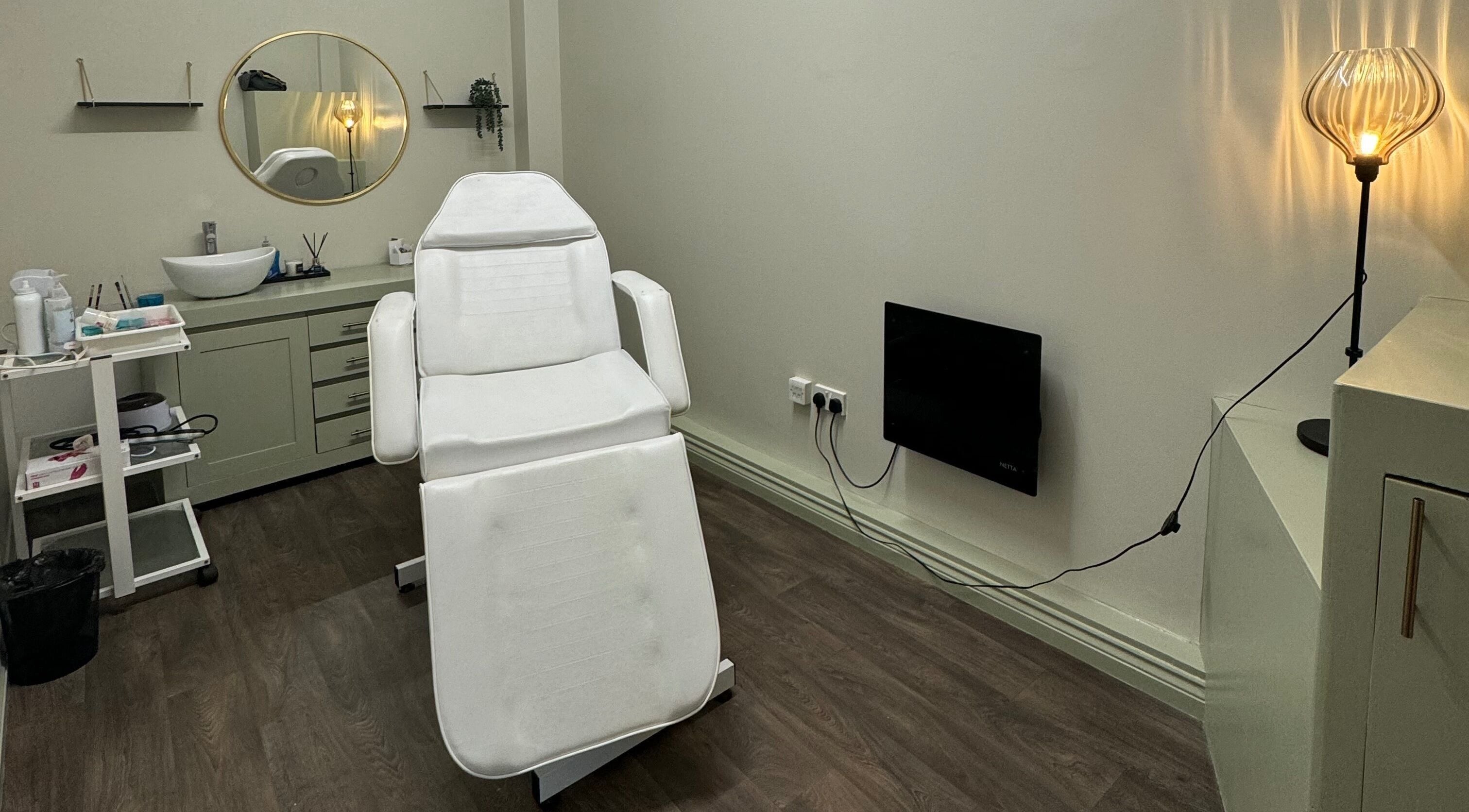 Relaxed ambiance at Bliss Beauty Bar treatment room in Ramsey, Ramsey, IM, featuring a comfortable spa chair.