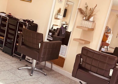 Bobbypins stylish salon interior with brown chairs and mirrors, Bromsgrove, England, GB.