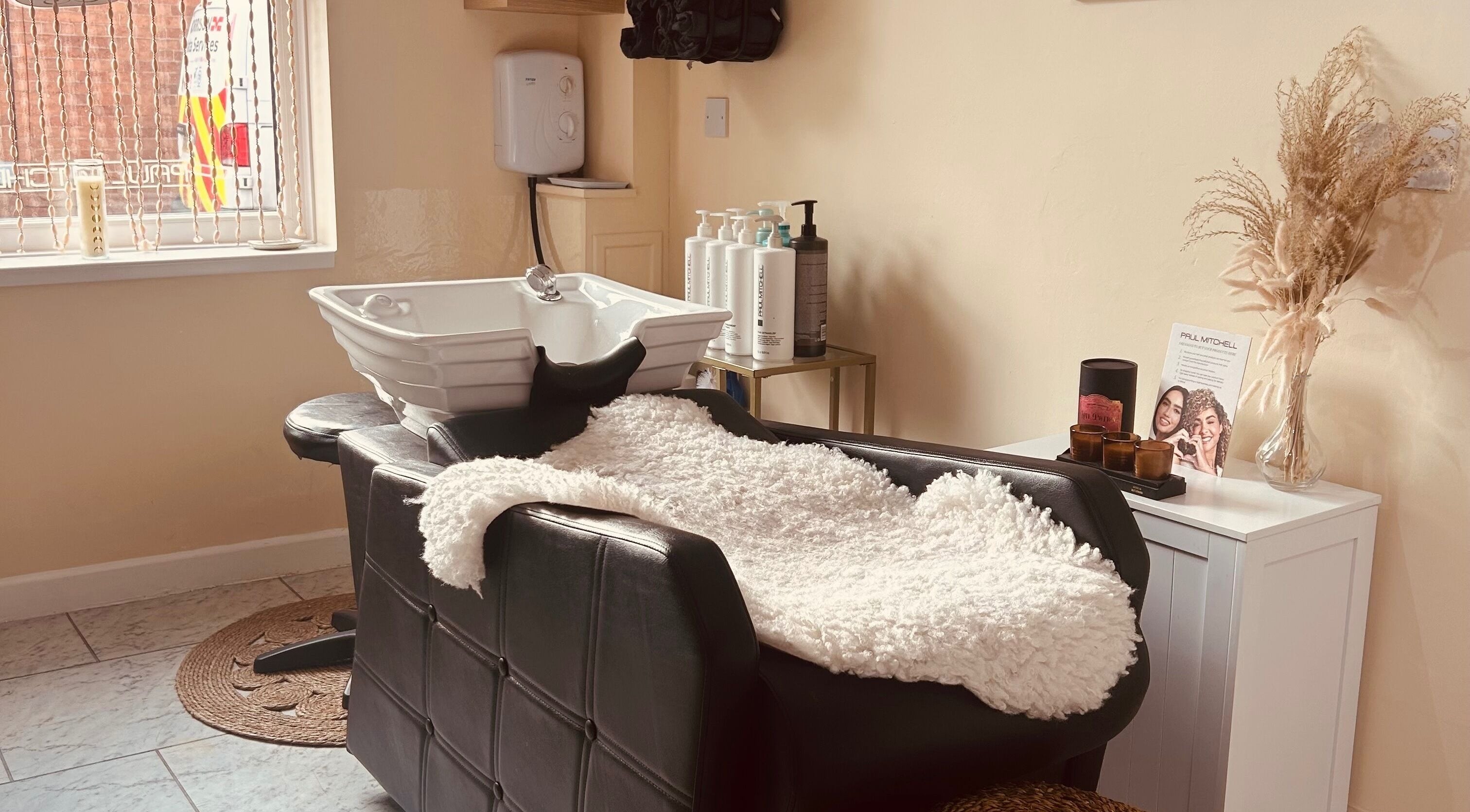 Cozy wash station at Bobbypins, Bromsgrove, England, GB, inviting new clients to relax and enjoy treatments.