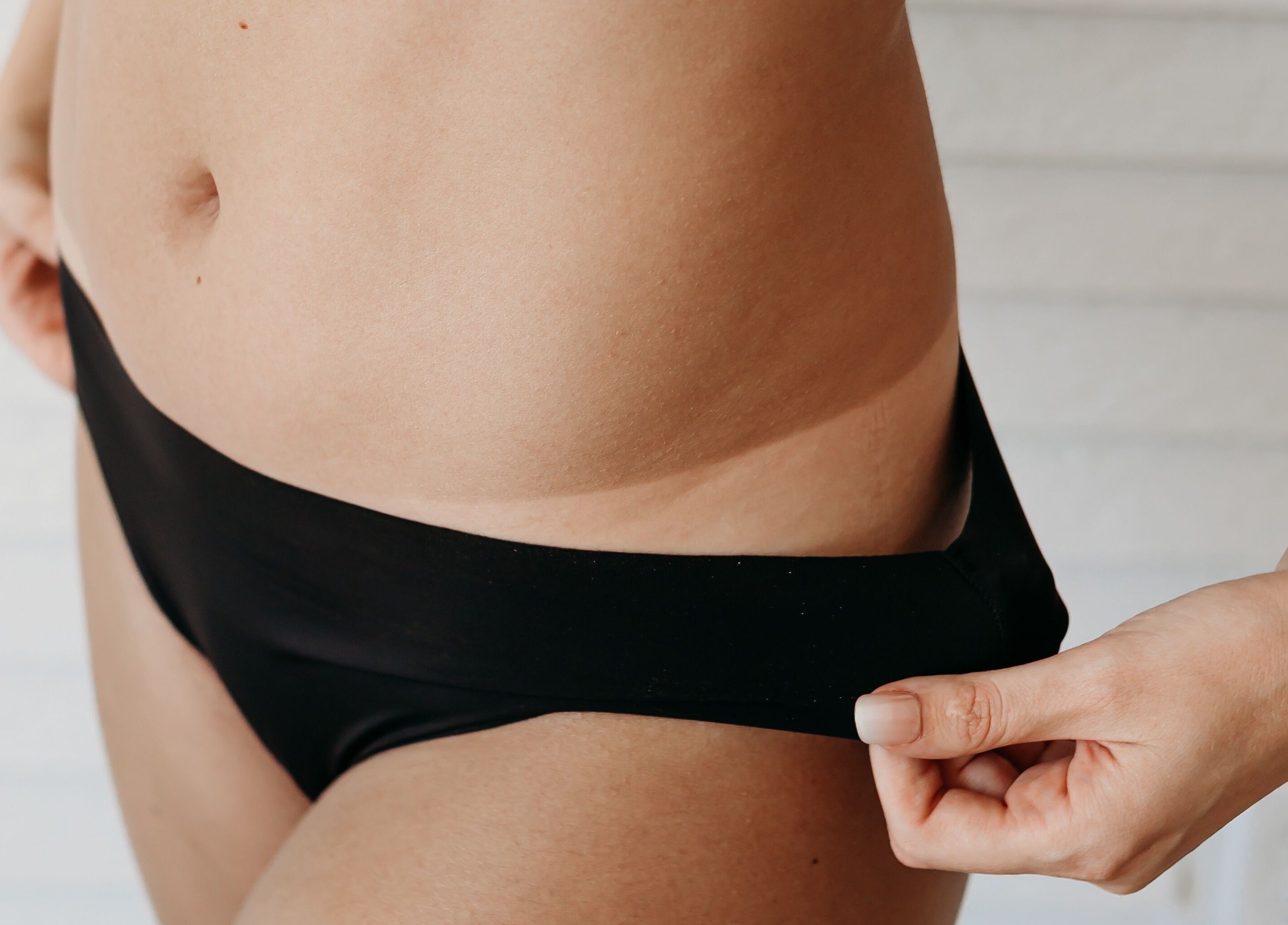 Close-up of chic black swimwear at Sprayed by Frazier Made, Oak Grove, Missouri, US.