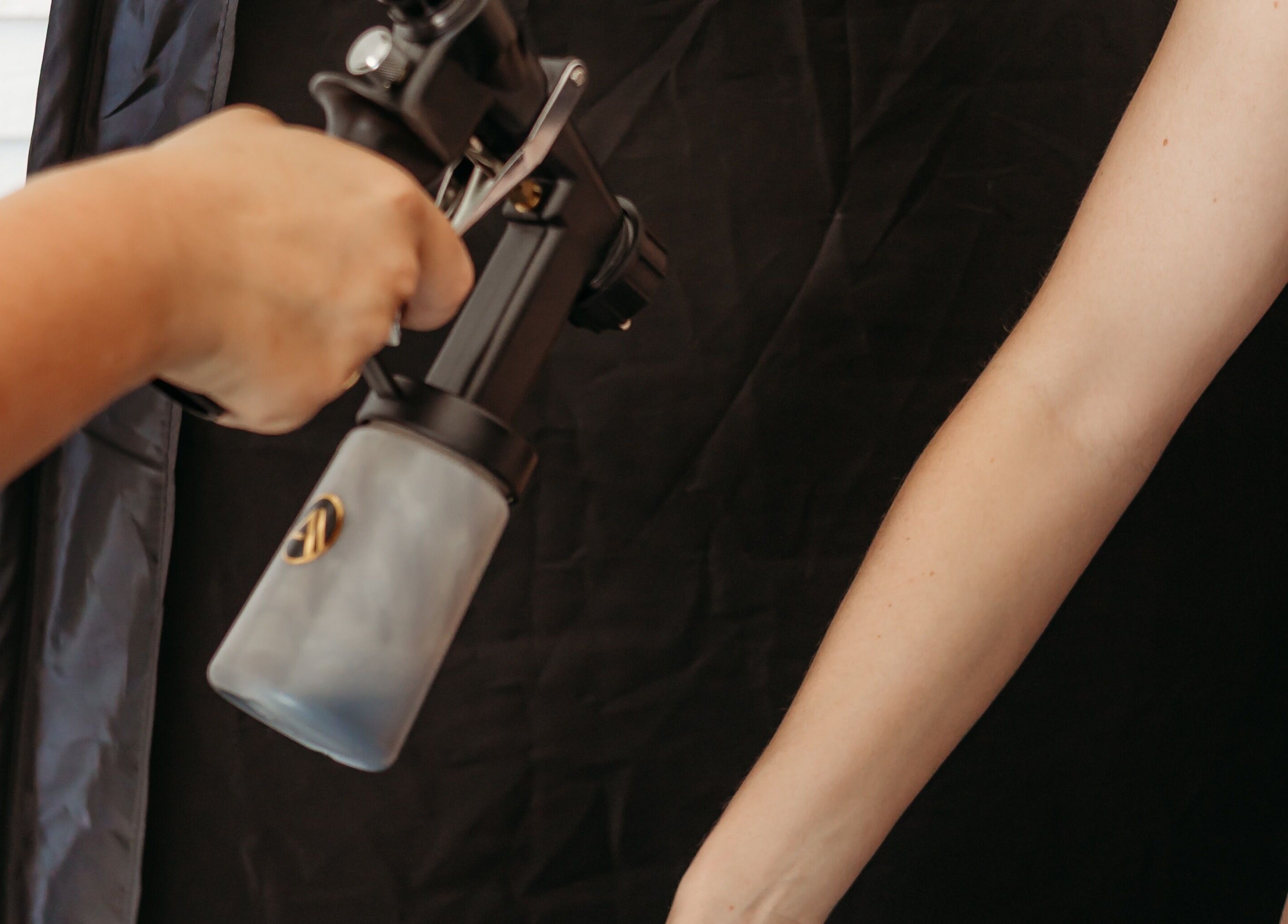 Airbrush tanning in action at Sprayed by Frazier Made, Oak Grove, Missouri, US.