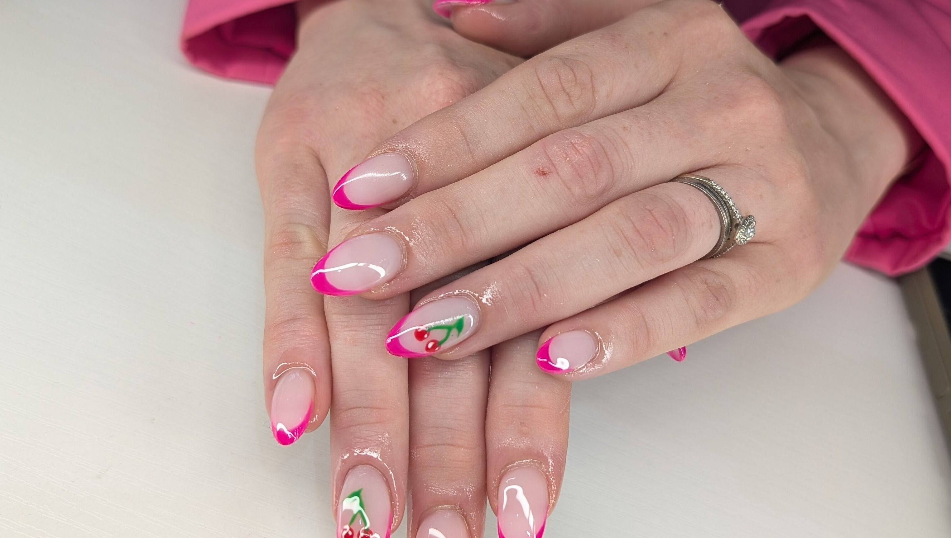 Elegant pink and cherry nail design at Beyond Beauty, Blyth, England, GB showcasing intricate artistry.