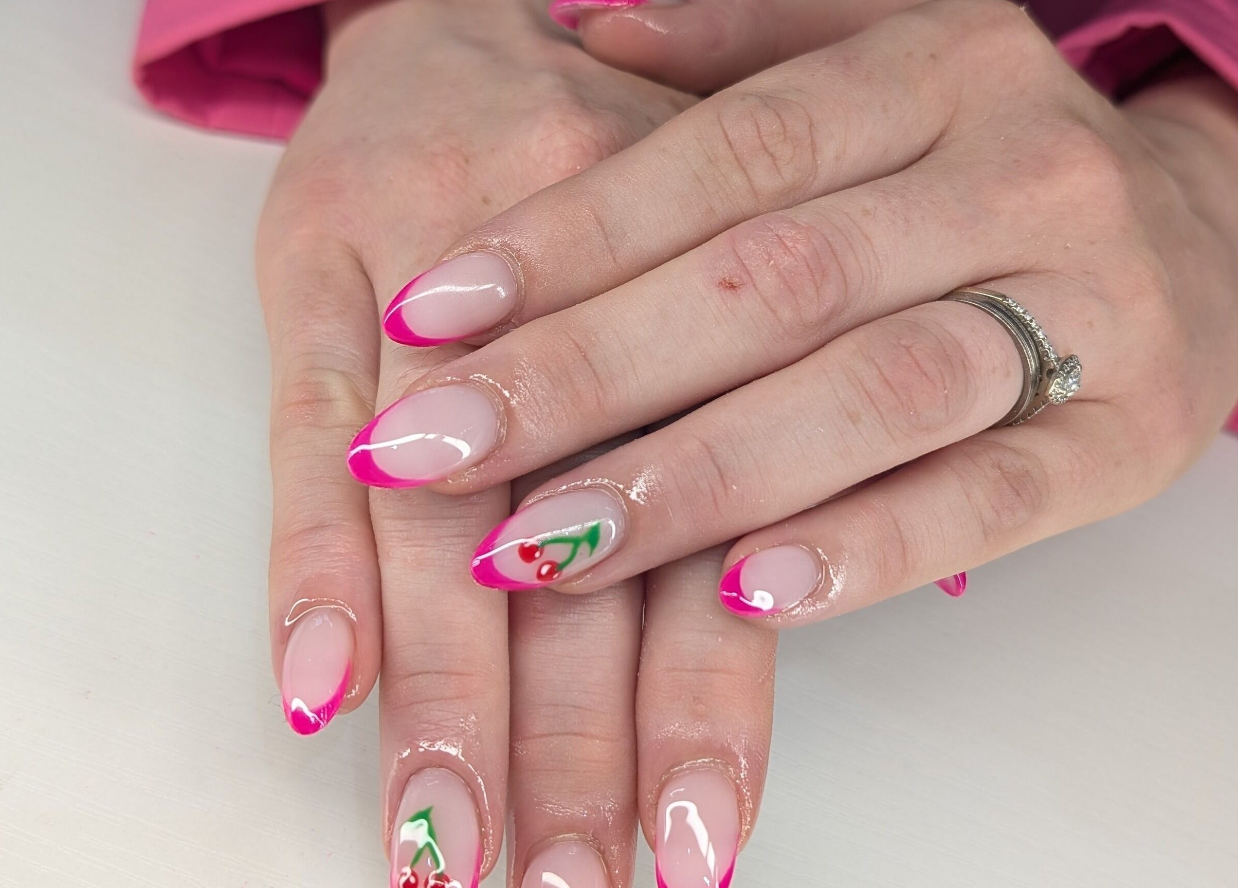 Elegant pink and cherry nail design at Beyond Beauty, Blyth, England, GB showcasing intricate artistry.