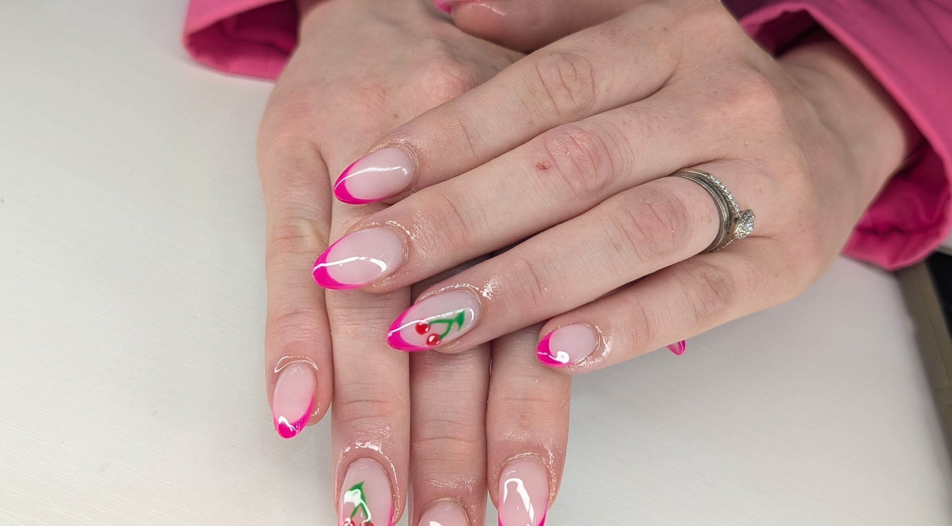 Elegant pink and cherry nail design at Beyond Beauty, Blyth, England, GB showcasing intricate artistry.