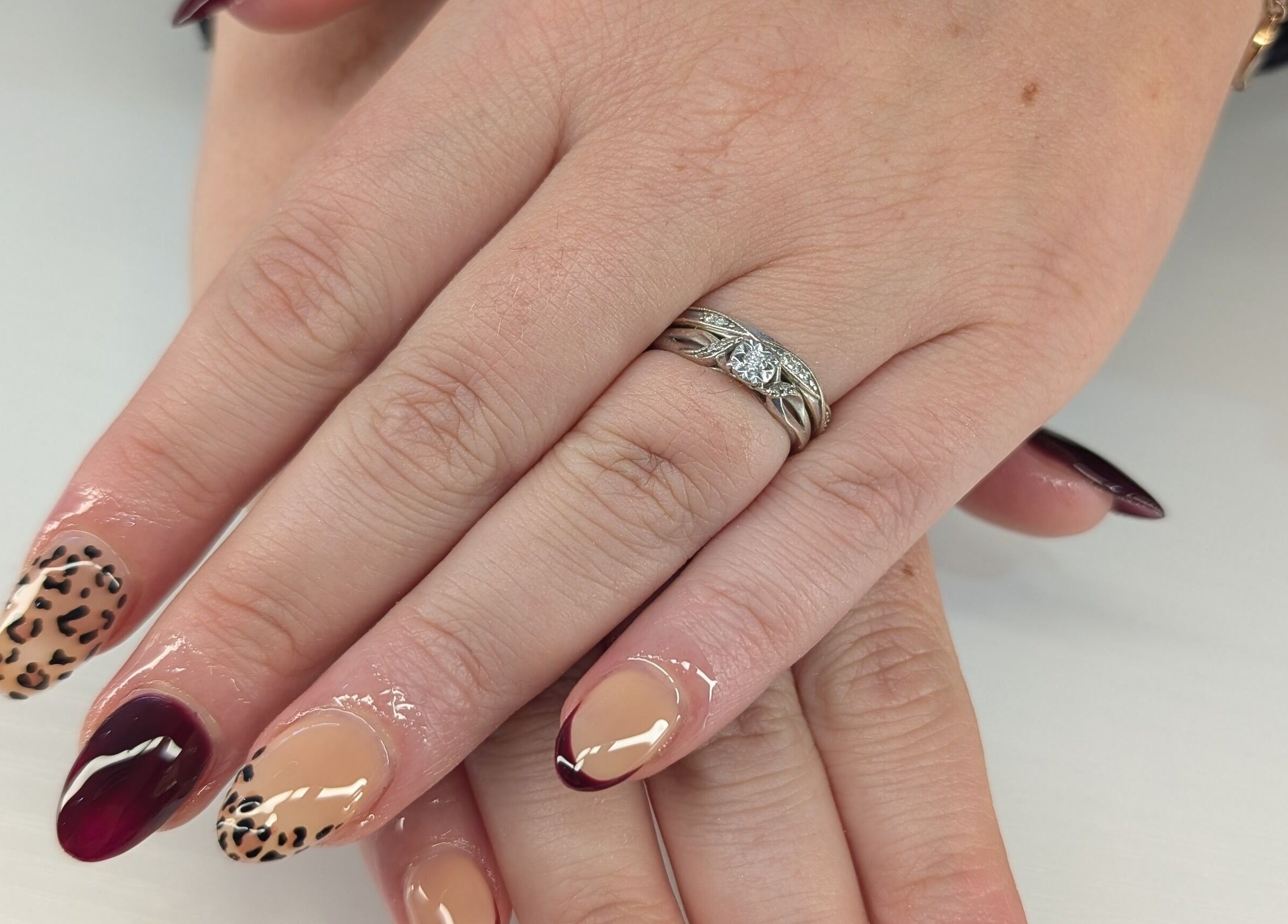 Stylish leopard print and wine red nails at Beyond Beauty, Blyth, England, GB.