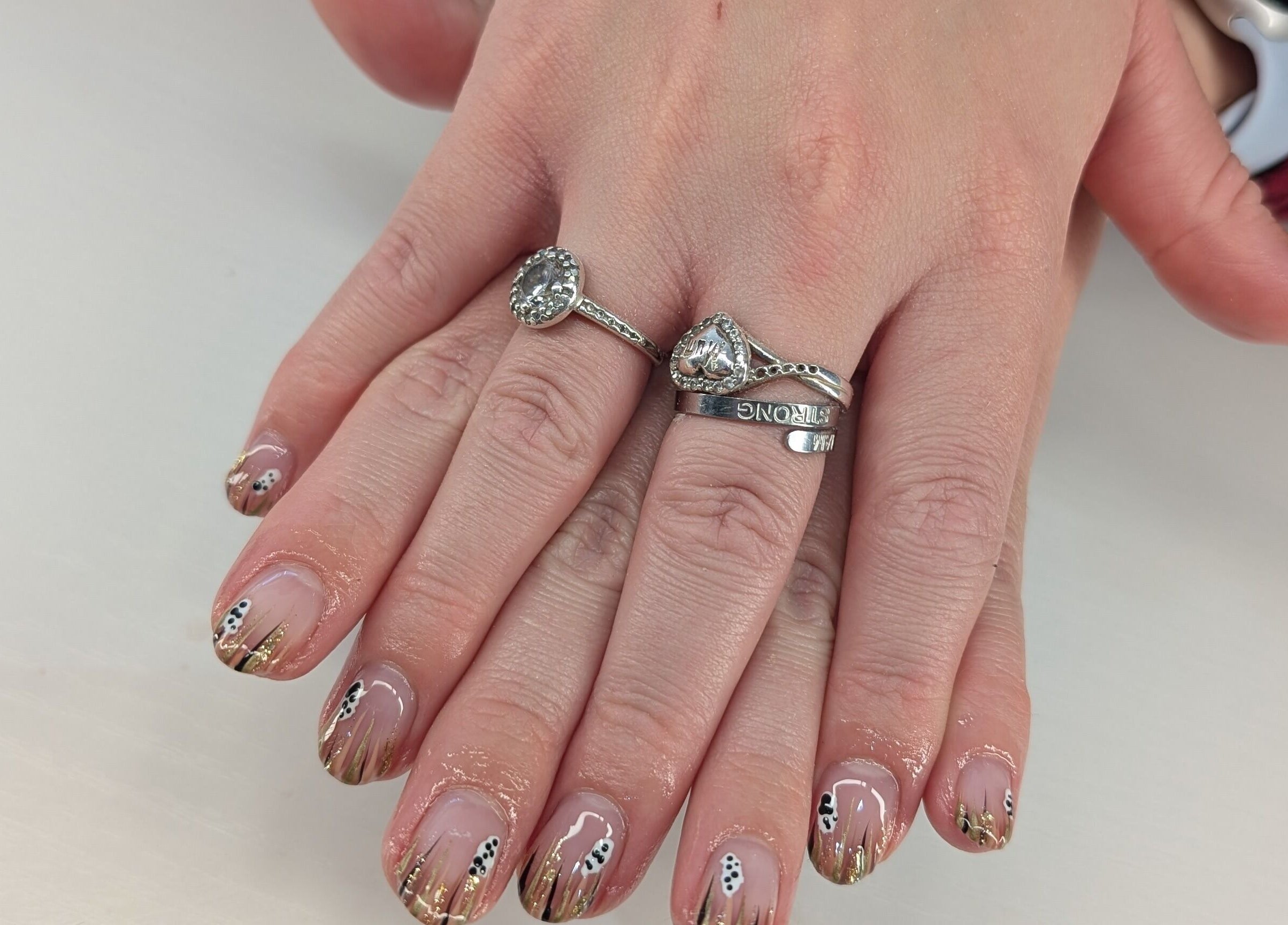 Manicured hands with intricate nail art at Beyond Beauty, Blyth, England, GB.