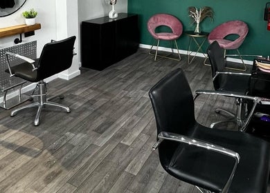 Modern salon interior at Piera's Hair Studio, Peterborough, England, GB, featuring stylish chairs and decor.