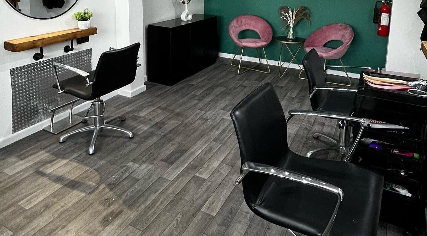 Modern salon interior at Piera's Hair Studio, Peterborough, England, GB, featuring stylish chairs and decor.