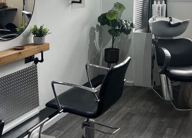 Elegant styling station at Piera's Hair Studio in Peterborough, England, GB with modern chairs and mirror.