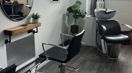 Elegant styling station at Piera's Hair Studio in Peterborough, England, GB with modern chairs and mirror.