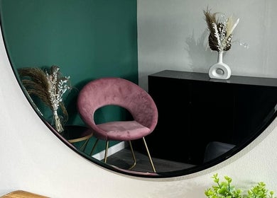 Elegant corner with pink chair seen in mirror at Piera's Hair Studio, Peterborough, England, GB.