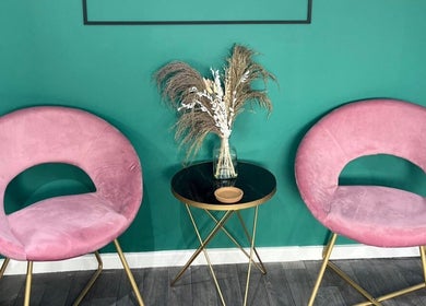 Chic seating area with pink chairs at Piera's Hair Studio, Peterborough, England, GB.
