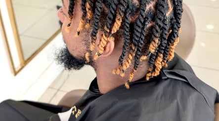 Stylish twisted hair design at Romaiya Beauty Bar, London, England, GB showcasing modern grooming.