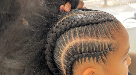 Intricate braids styled at Romaiya Beauty Bar, London, England, GB showcasing expert hair artistry.