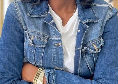 Close-up of a person in denim jacket at Romaiya Beauty Bar, London, England, GB.