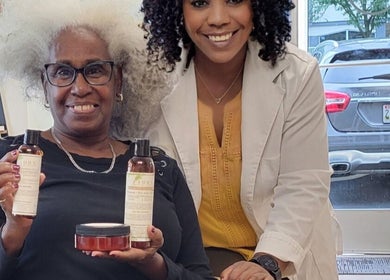 Happy client and specialist at A'daora Trichology & Wellness Inst., Towson, Maryland, US, showcasing hair products.