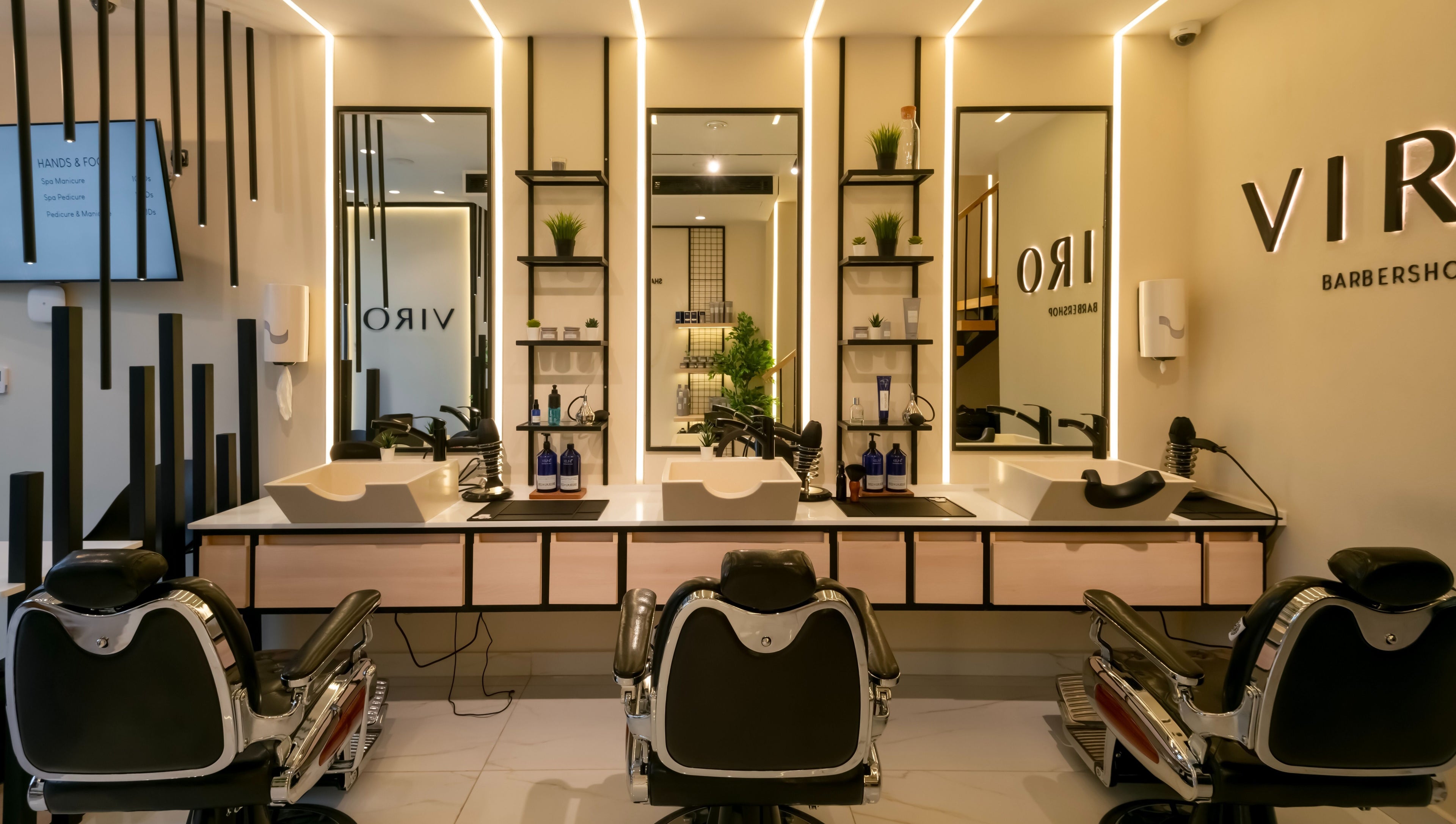 Modern interior of VIRO Barbershop - AL Nakheel in Amman, featuring sleek chairs and mirrors.