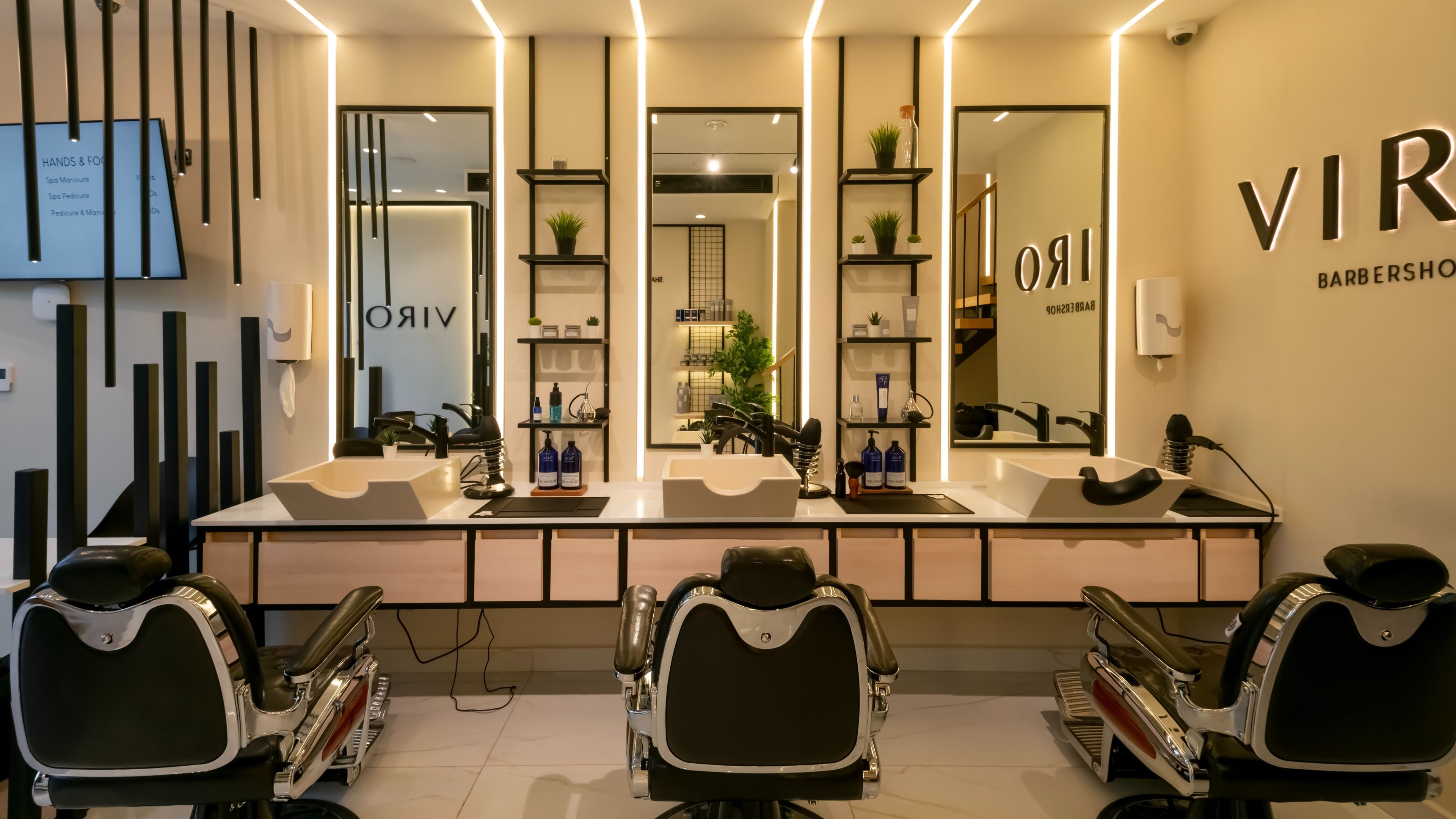 Modern interior of VIRO Barbershop - AL Nakheel in Amman, featuring sleek chairs and mirrors.