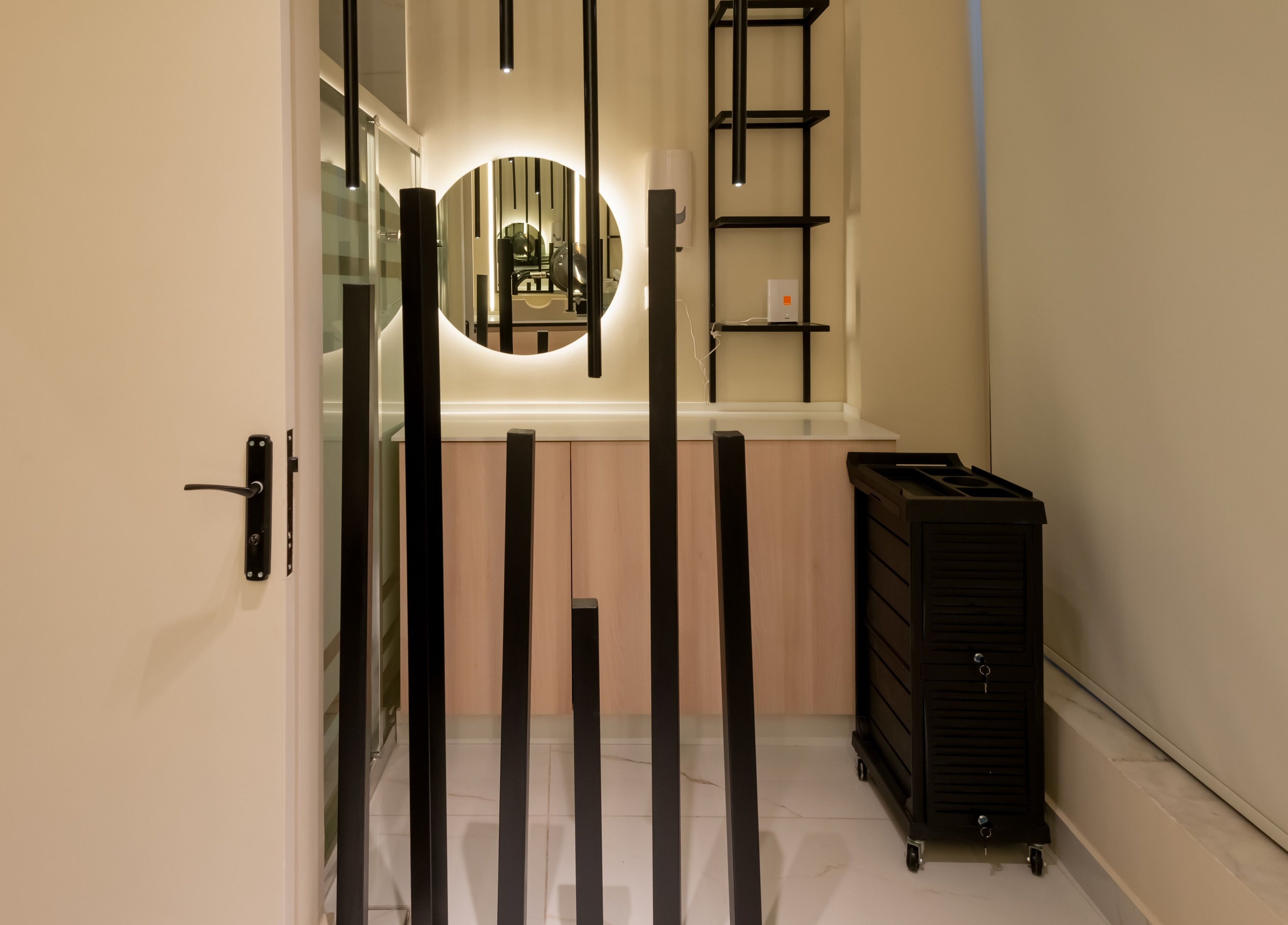 Modern interior of VIRO Barbershop - AL Nakheel in Amman, JO with stylish black fixtures and a sleek mirror.