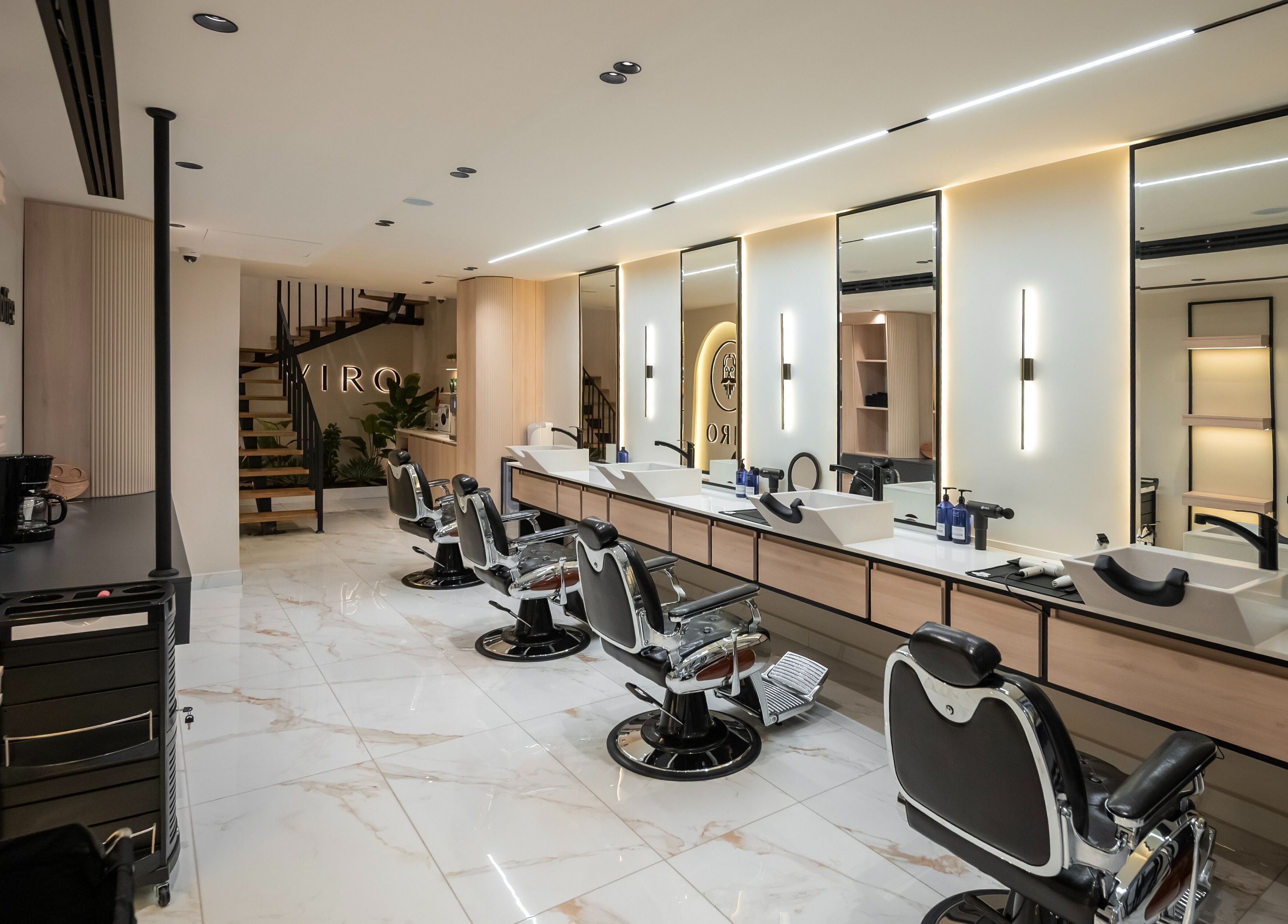 Modern interior of VIRO Barbershop Dabouq in Amman, Amman Governorate, JO with stylish chairs and sleek mirrors.