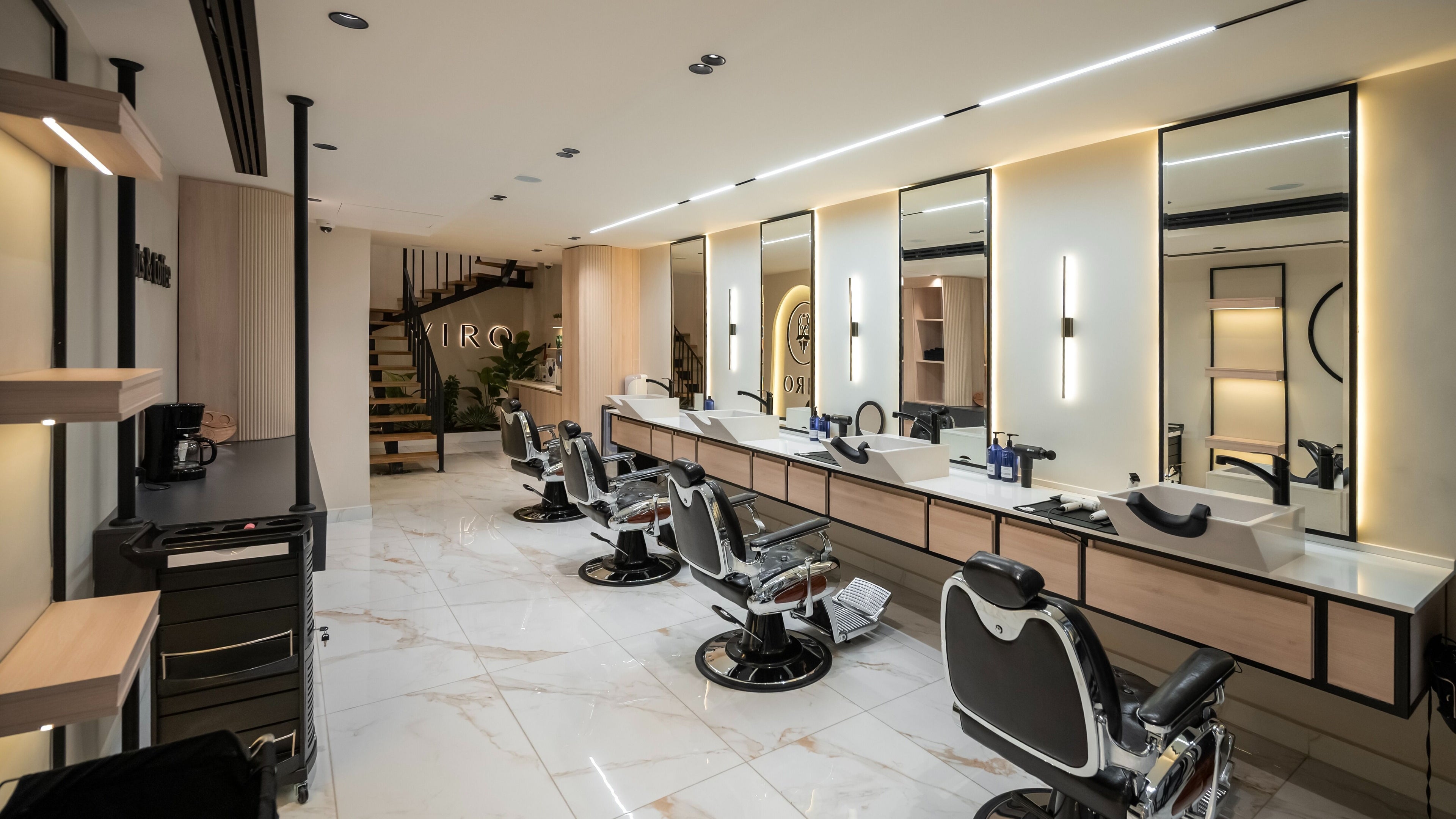 Modern interior of VIRO Barbershop Dabouq in Amman, Amman Governorate, JO with stylish chairs and sleek mirrors.