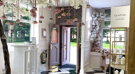 Entrance of Samantha’s Skin Clinic, Failsworth, England, with floral decorations and Olaplex products displayed.