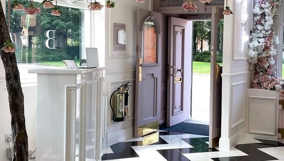 Welcoming entrance of Samantha’s Skin Clinic in Failsworth, England, GB with floral decor and a glossy floor.