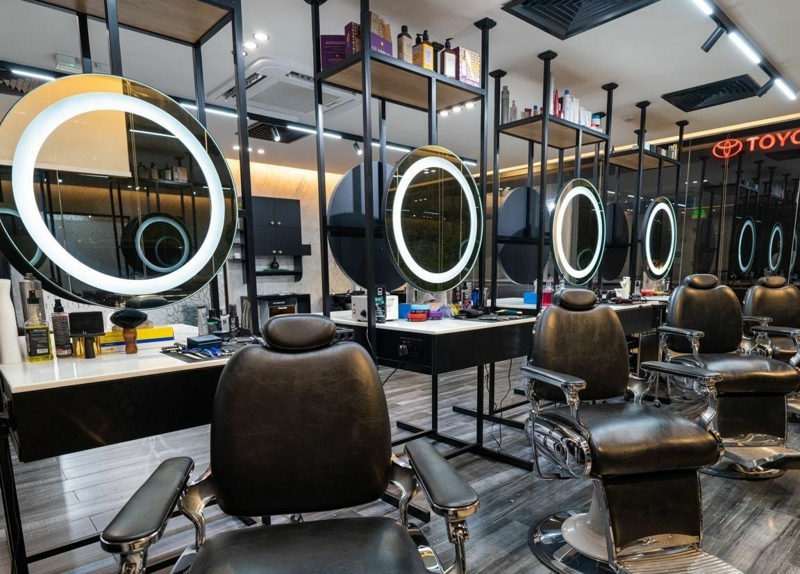 Elegant barber chairs at Sams Barber Men Care Center in Abu Dhabi, AE with modern lighting.