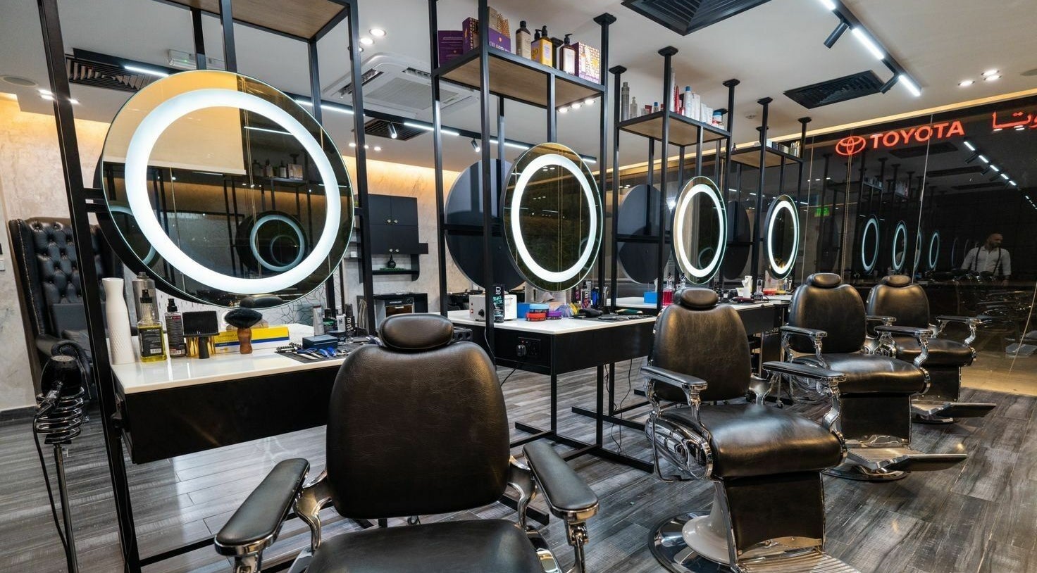 Elegant barber chairs at Sams Barber Men Care Center in Abu Dhabi, AE with modern lighting.