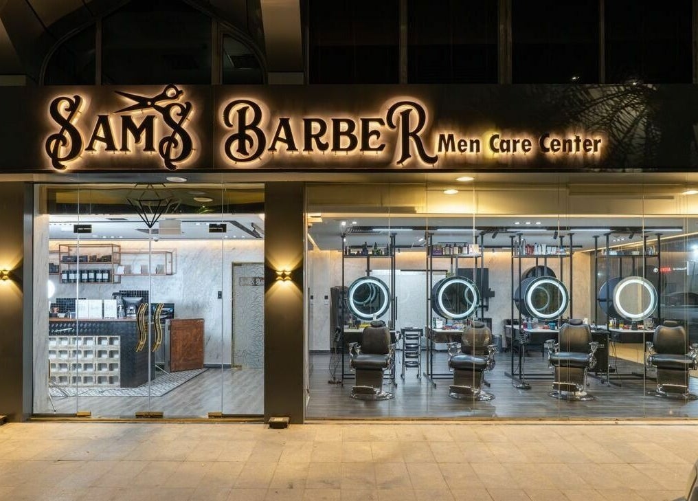 Sams Barber Men Care Center's elegant exterior at night in Abu Dhabi, Abu Dhabi, AE features inviting chairs.